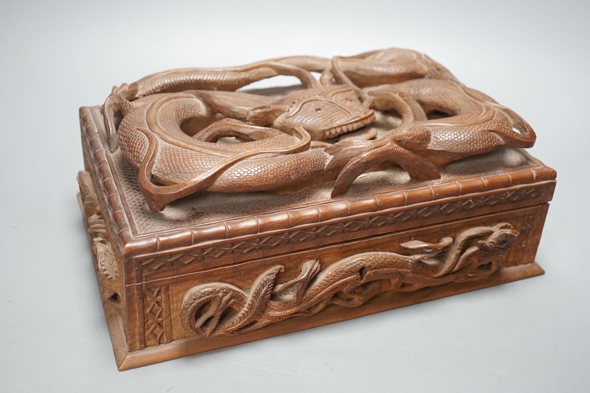 A Burmese carved wood 'Dragon' box, 31cm wide
